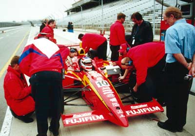 Derek Daly watches Jimmy Vasser